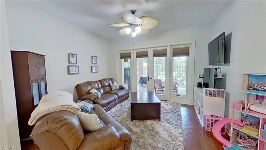 Living area with french doors, wood finished floors, and ceiling fan