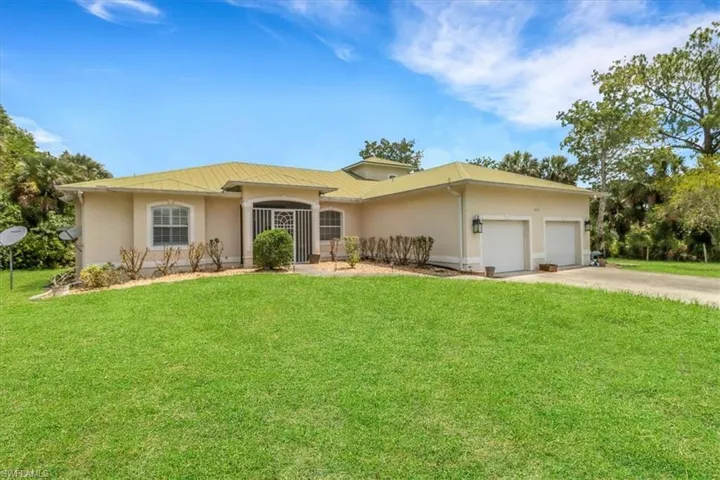 Ranch-style house with stucco siding, an attached garage, concrete driveway, and a front lawn