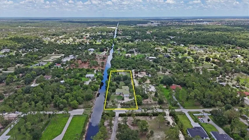 Aerial view of property and surrounding area with property parcel outlined