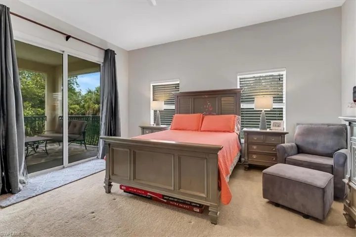 Bedroom featuring light carpet and access to exterior