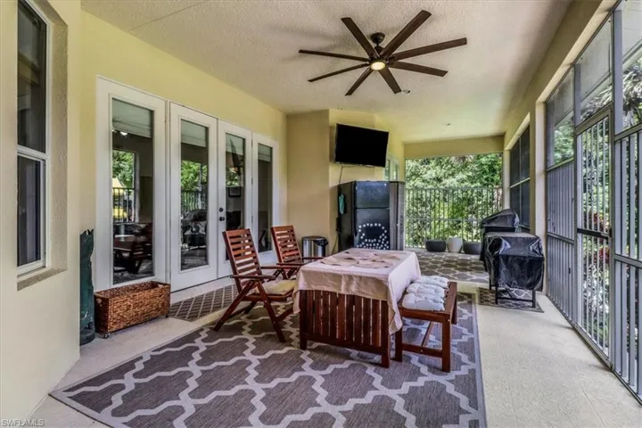 Sunroom / solarium with french doors, a ceiling fan, and healthy amount of natural light