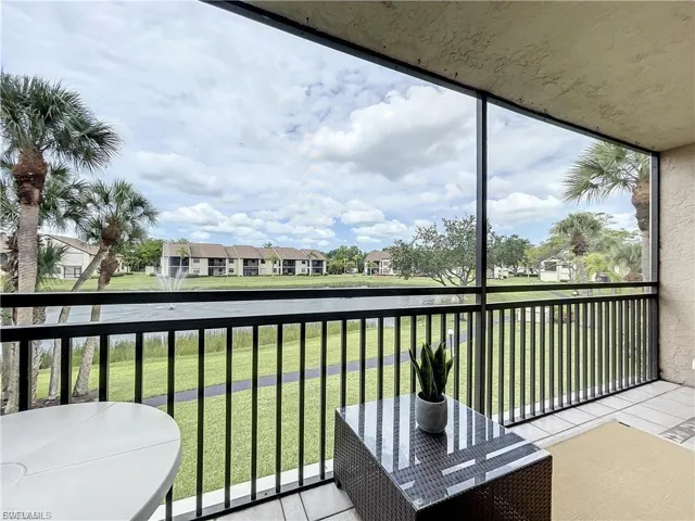 Balcony featuring a sunroom, a residential view, and a water view