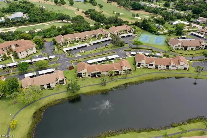 Aerial perspective of suburban area with a large body of water and a golf course