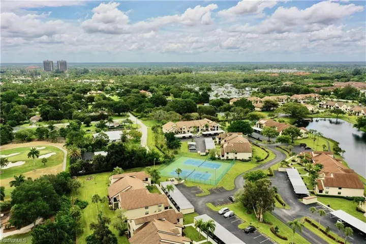Aerial view of residential area with a large body of water and a golf course