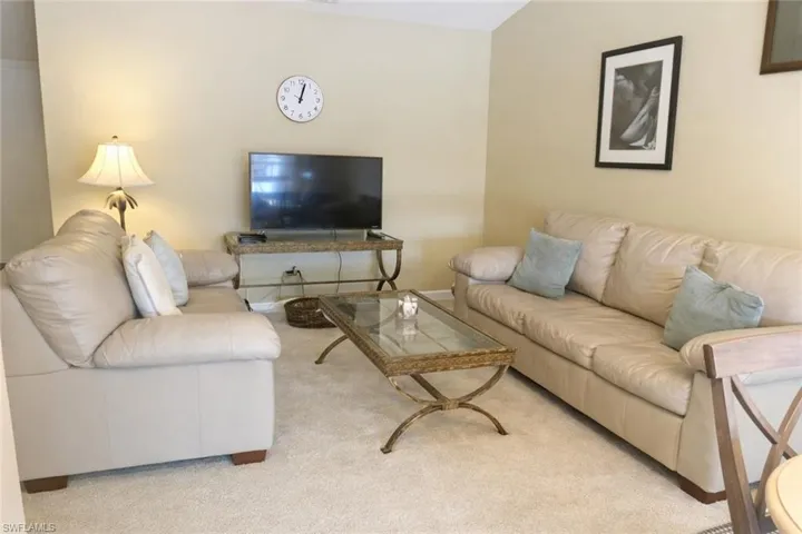 Living area featuring light carpet