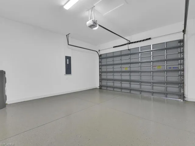 Garage with a garage door opener and electric panel
