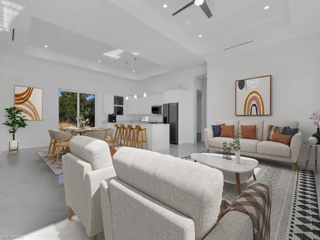 Living room with ceiling fan, towering ceiling, sink, and a tray 10' ceiling. Furnitures are not included.