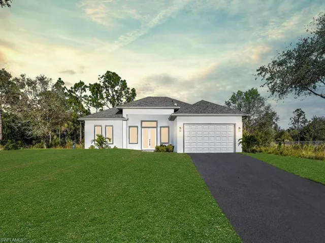 Prairie-style house with a lawn and a 2 cars garage