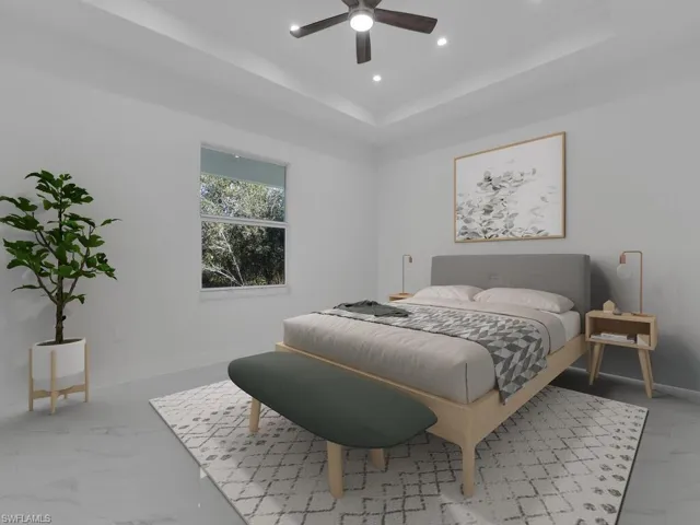 Primary Bedroom featuring a tray ceiling and ceiling fan. Furnitures are not included.