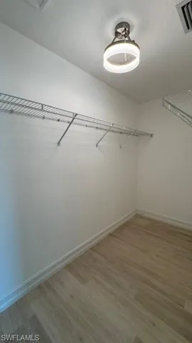 Walk in closet featuring light wood-type flooring