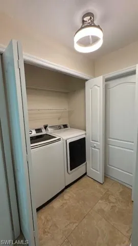 Washroom featuring washer and dryer