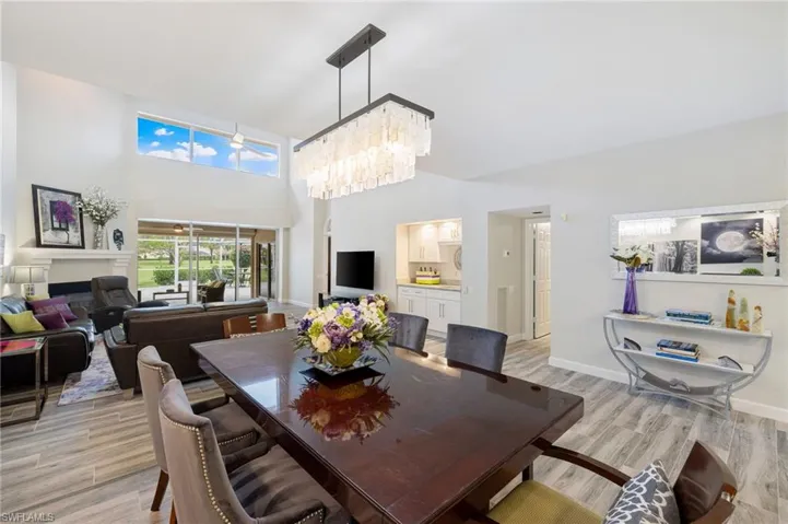 Dining area with a chandelier, a high ceiling, and light hardwood / wood-style flooring