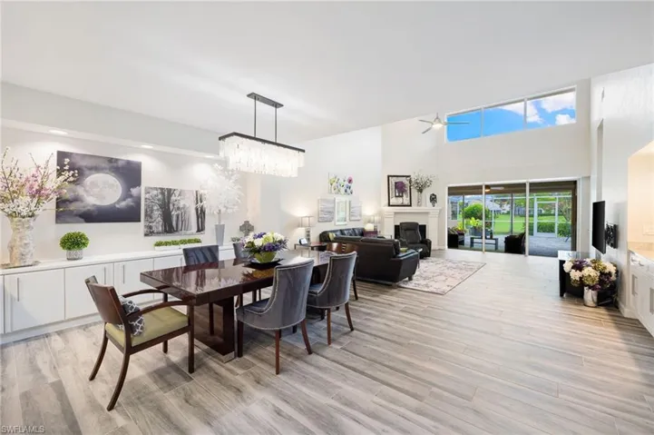 Dining room featuring light hardwood / wood-style floors and ceiling fan with notable chandelier