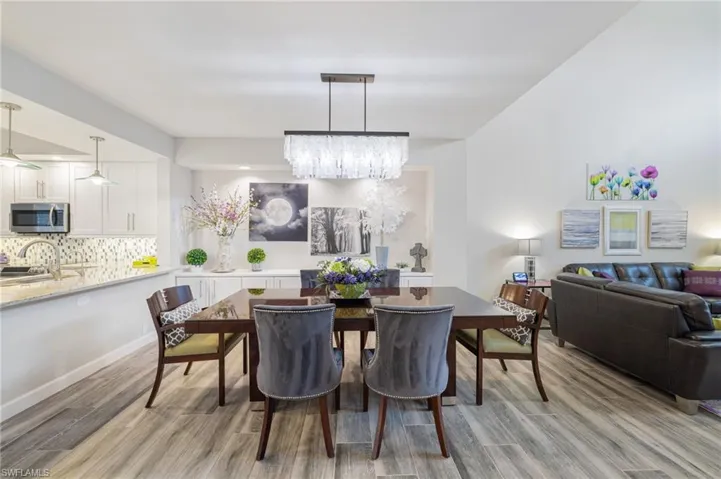 Dining space featuring light hardwood / wood-style flooring and an inviting chandelier