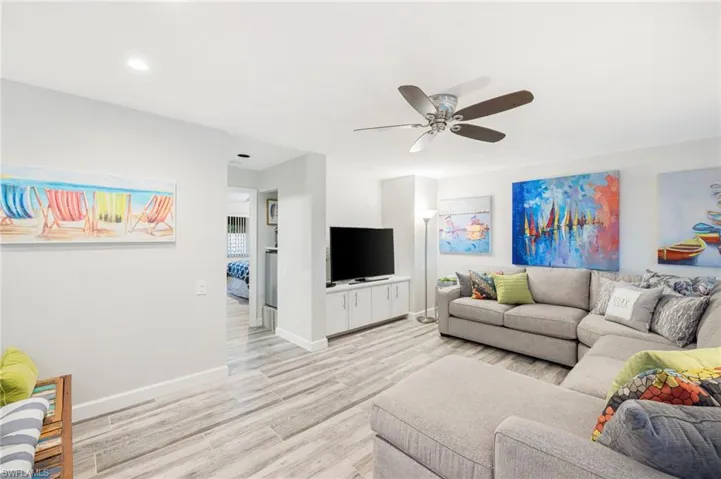 Living room featuring ceiling fan and light wood-type flooring