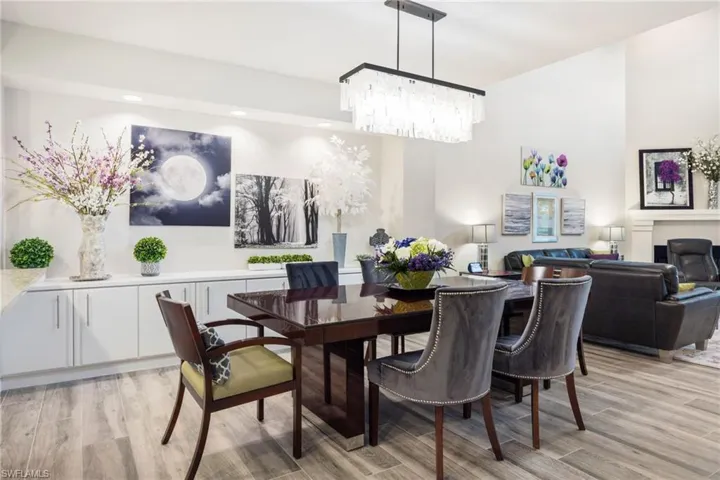 Dining area with a notable chandelier and light wood-type flooring