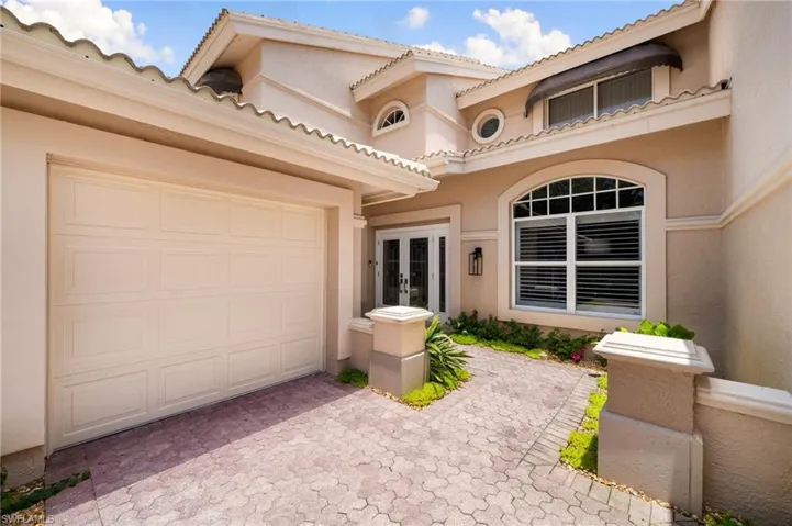 Doorway to property featuring a garage and french doors