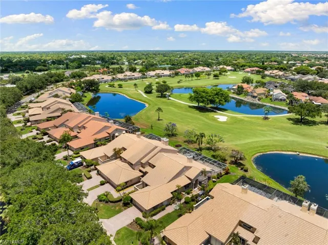 Birds eye view of property with a water view