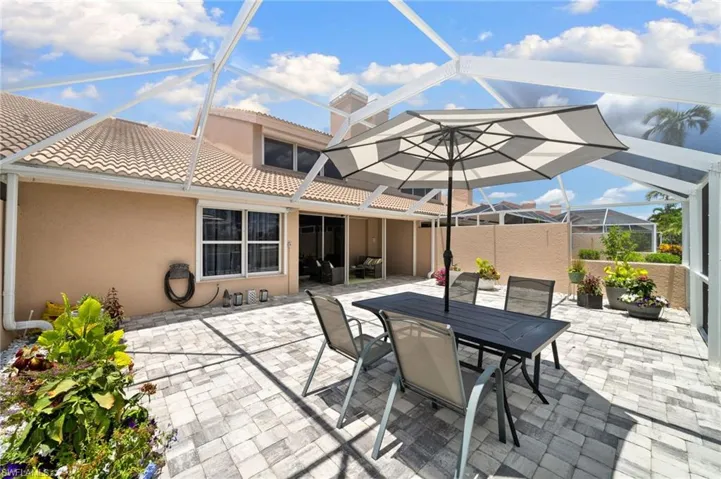 View of patio featuring a lanai