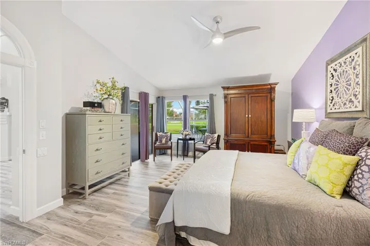 Bedroom featuring high vaulted ceiling, light wood-type flooring, and ceiling fan