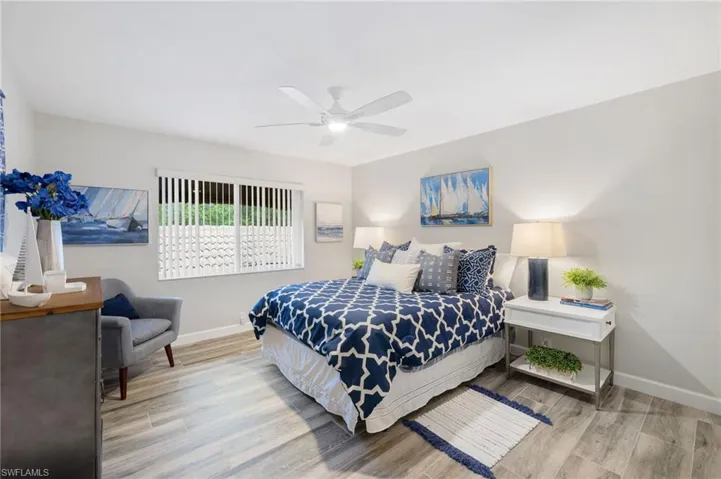 Bedroom with ceiling fan and light wood-type flooring