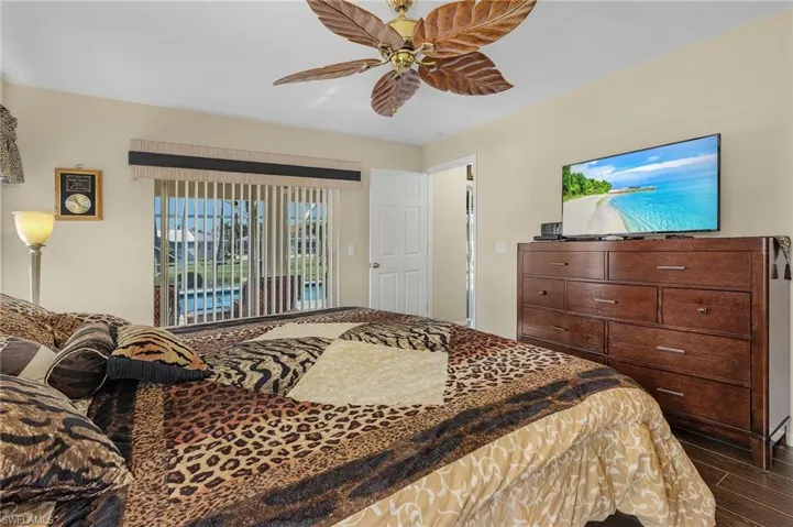 Master Bedroom; featuring sliding glass door access to patio and pool