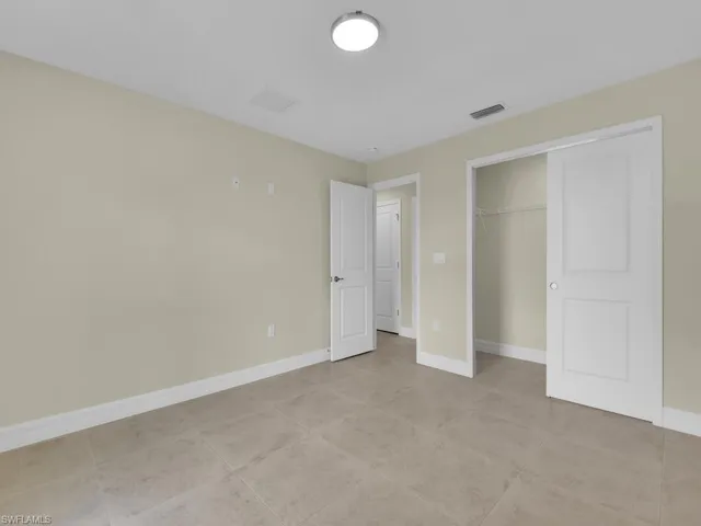 Unfurnished bedroom with a closet