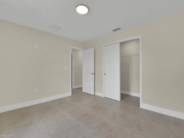 Unfurnished bedroom with light tile patterned floors and a closet