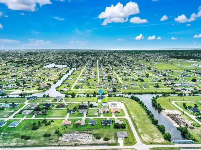 Birds eye view of property with a water view