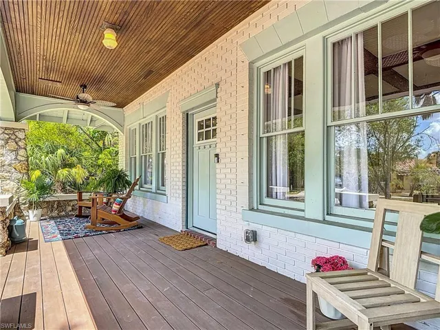 Wooden terrace with a porch and ceiling fan