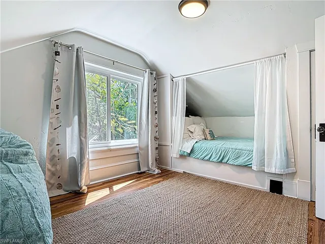 Bedroom featuring vaulted ceiling and wood finished floors
