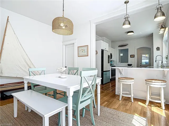 Dining room with light wood-style floors and ornamental molding