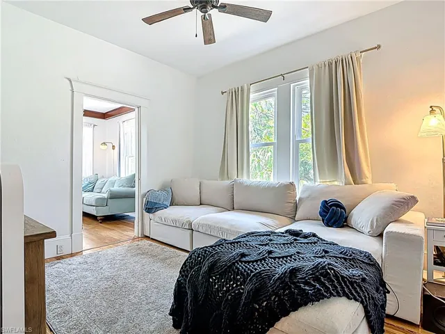Bedroom with baseboards, ceiling fan, and wood finished floors