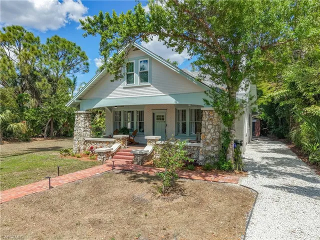 View of front of property with covered porch and stone siding