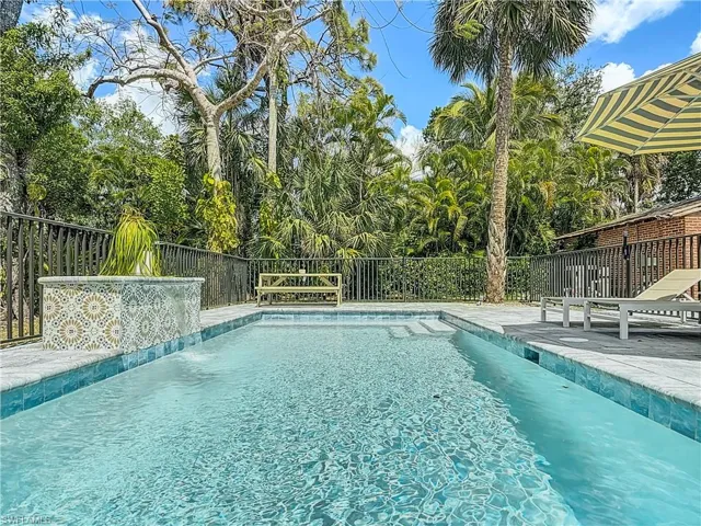 View of swimming pool featuring a patio, fence, and a fenced in pool