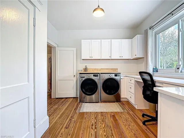 Laundry area featuring washing machine and clothes dryer and wood finished floors