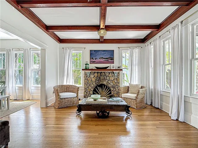 Sitting room featuring a wealth of natural light, a fireplace, and hardwood / wood-style floors