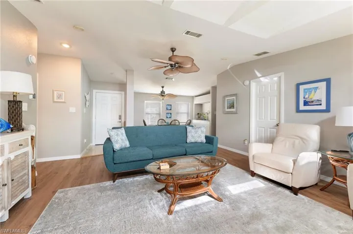 Living room with wood laminate finished floors and ceiling fan