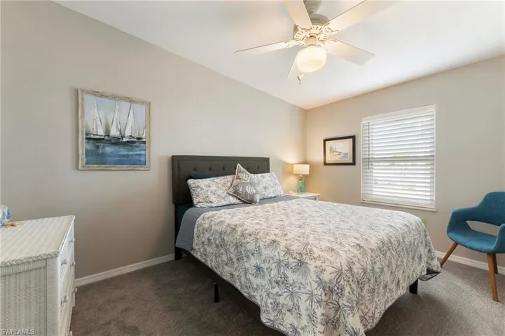 Carpeted bedroom with baseboards and ceiling fan
