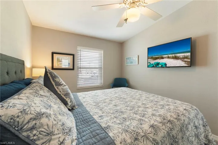 Bedroom with ceiling fan and vaulted ceiling