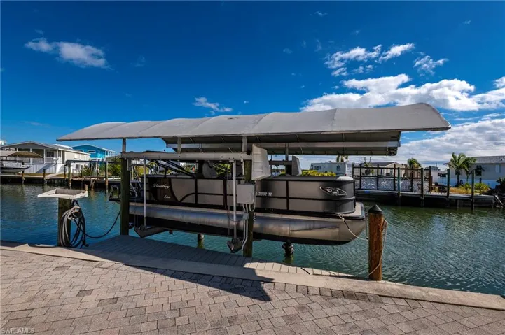 Dock with boat lift and a water view
