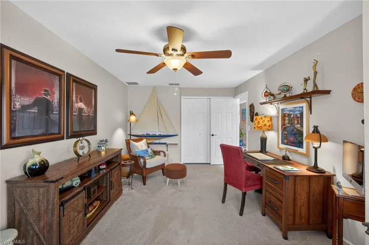 Carpeted room featuring a ceiling fan, two-panel bifold closet doors, and recessed lighting