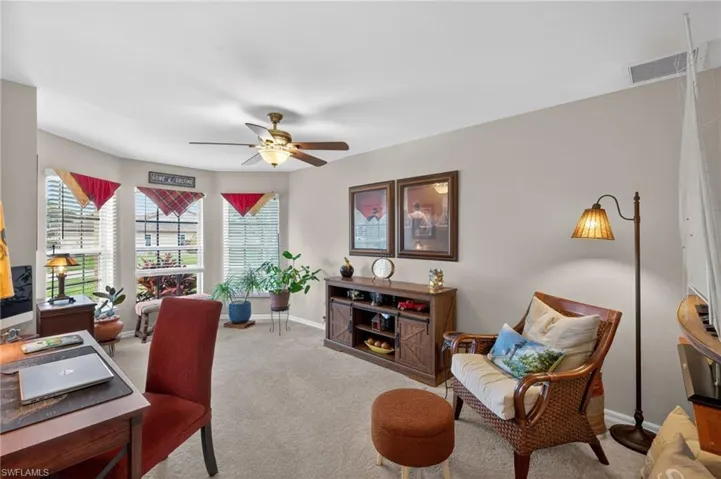 Room featuring a bay window, neutral wall paint, and carpet flooring
