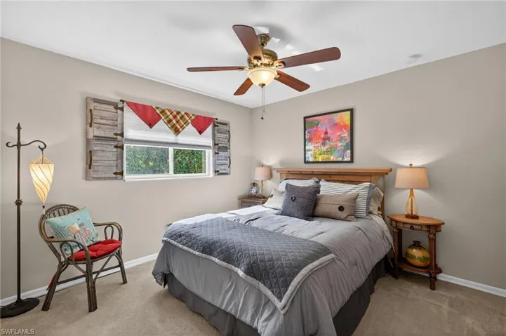Well-lit room featuring light-colored walls and carpet flooring