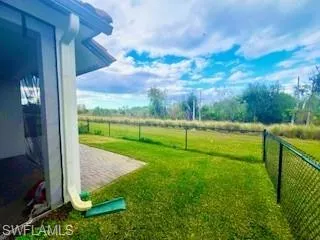 Fenced backyard with a patio and a view of countryside
