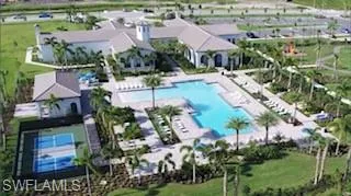 Aerial overview of property's location featuring a pool area and nearby suburban area