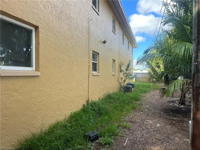 View of side of home with stucco siding