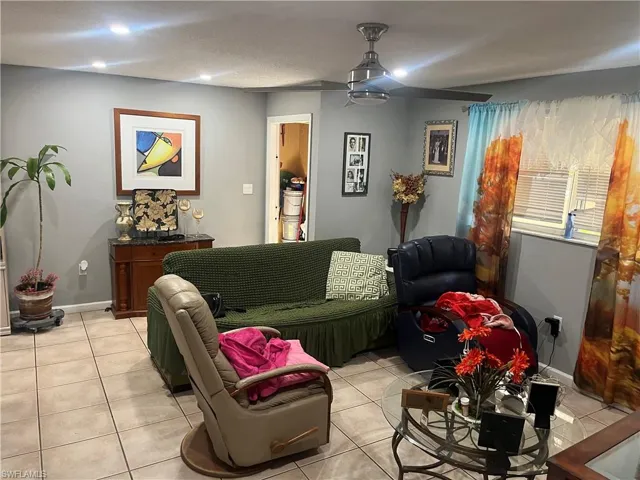 Living room featuring light tile patterned floors and recessed lighting