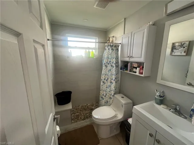 Full bathroom featuring vanity and a tile shower