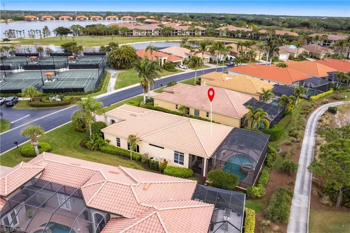 Aerial perspective of suburban area featuring a nearby body of water